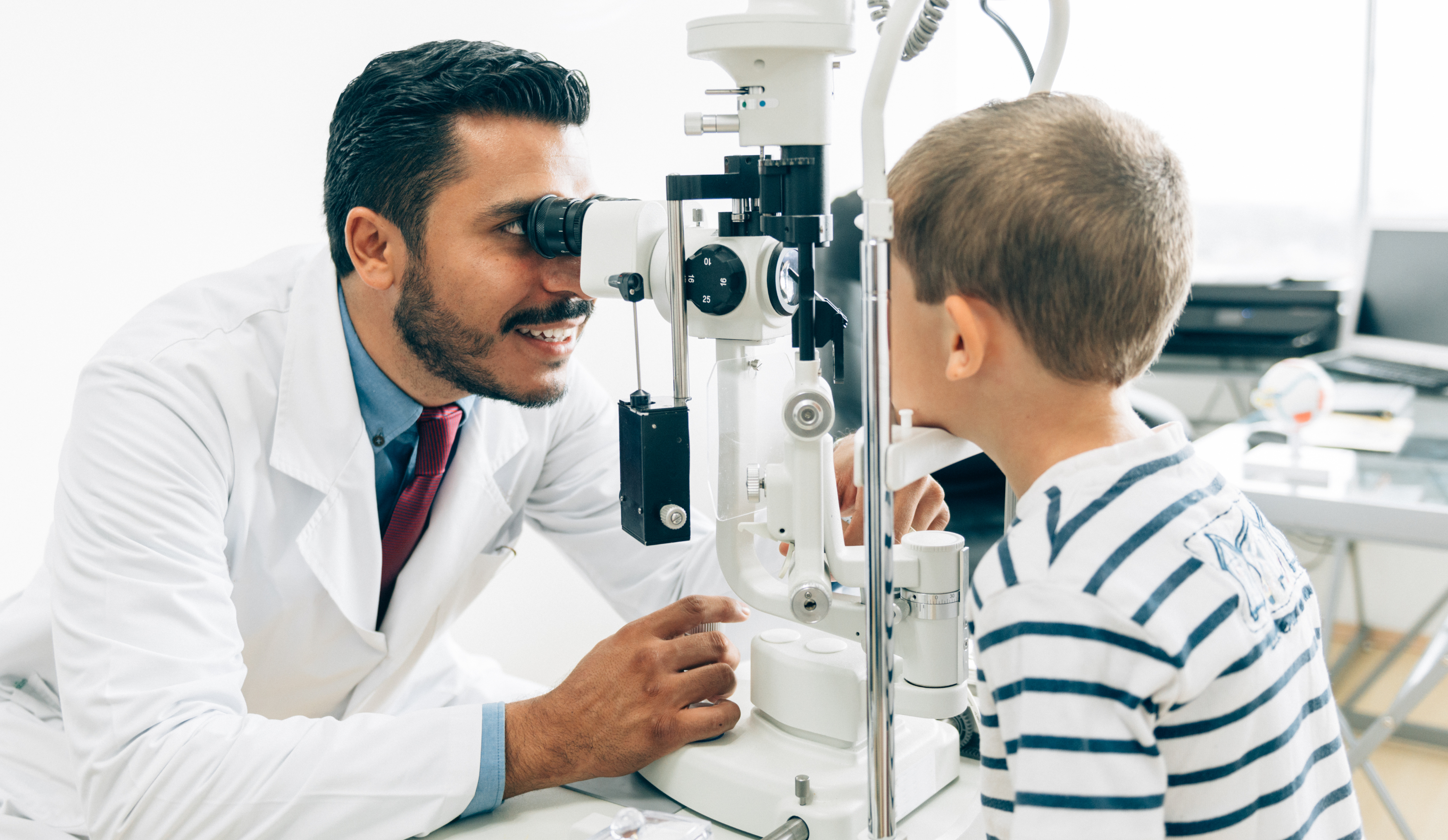 Optometrist examining a young patient's eyes.